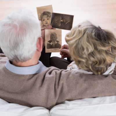 senior couple looking at old photos